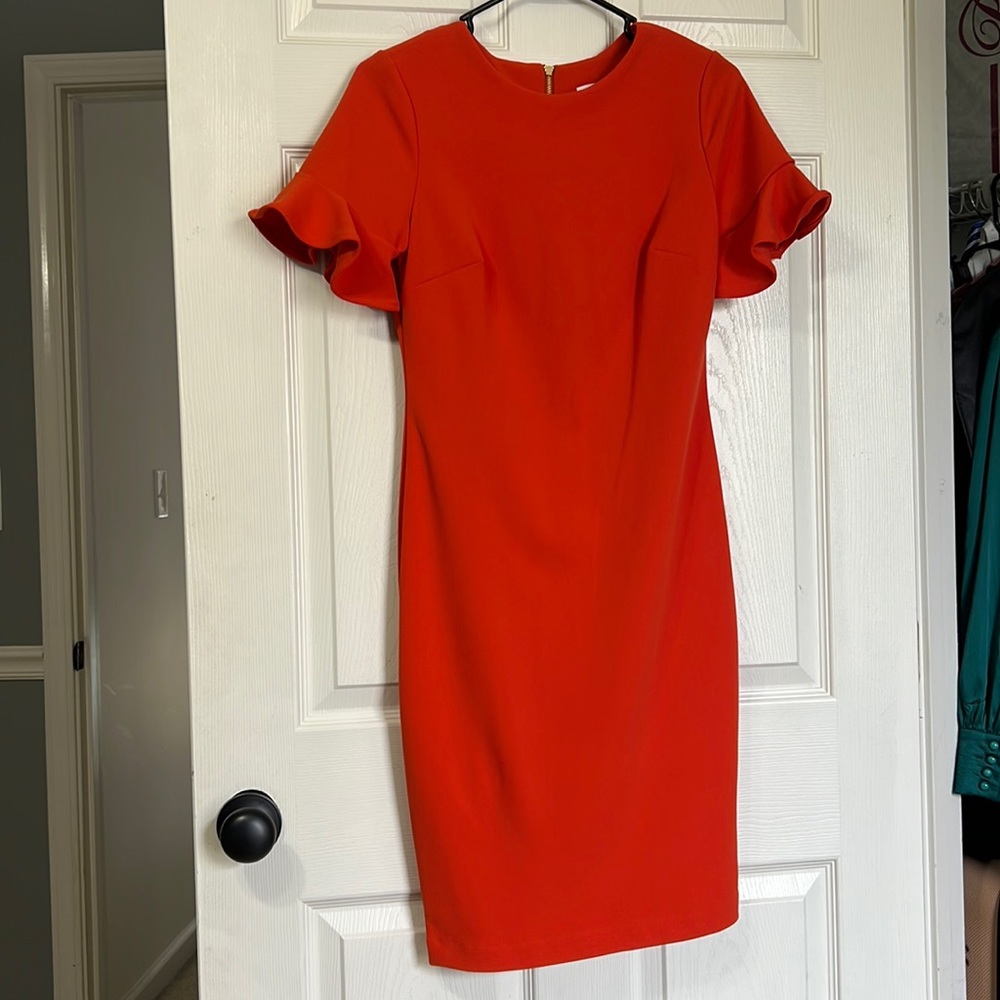Orange Midi Dress with ruffles in sleeves by Calvin Klein. Size 4. Worn once.